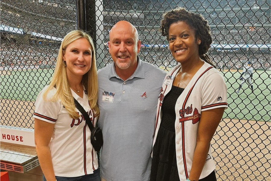 Orthodontist and two team members at a baseball game