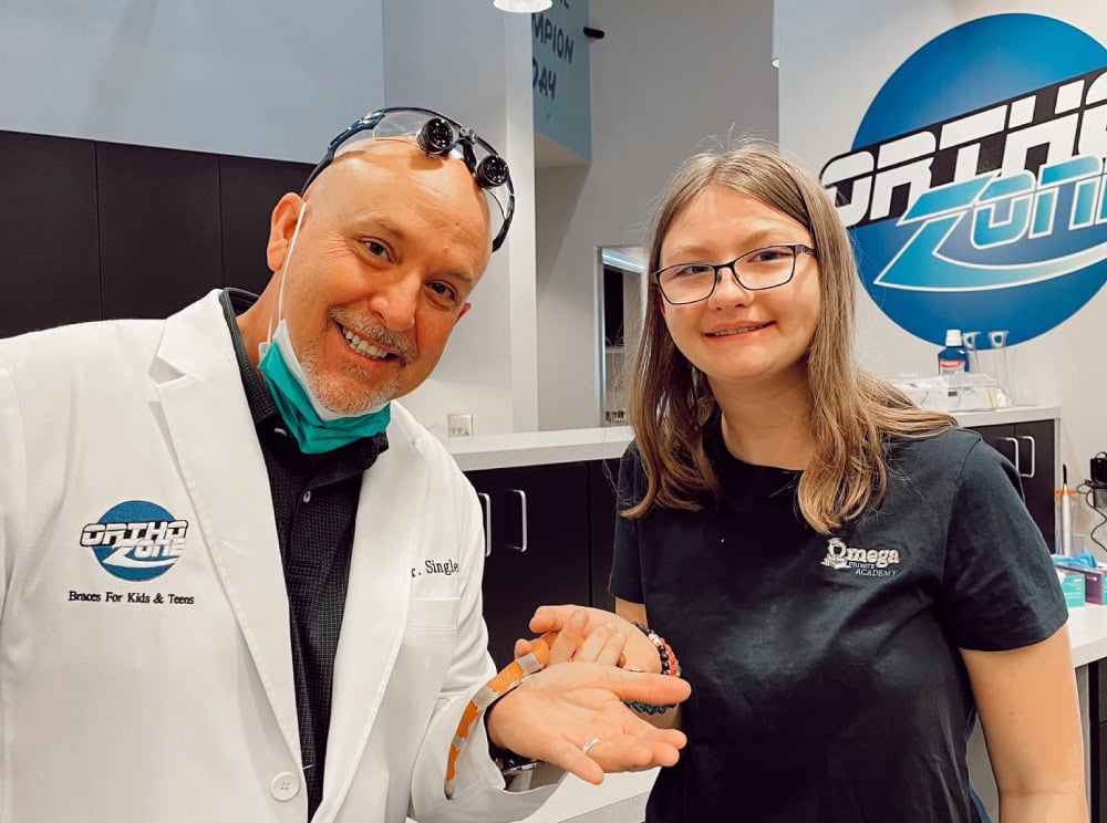 Orthodontist posing with teen patient